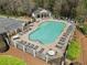 Aerial view of a community pool featuring lounge chairs and tables for relaxing by the water at 144 Nocatee Trl, Woodstock, GA 30188