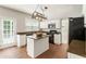 Cozy kitchen with island, granite countertops, white cabinets, and stainless steel appliances at 144 Nocatee Trl, Woodstock, GA 30188