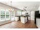 Bright kitchen features white cabinets, an island, stainless steel appliances, and tile flooring at 144 Nocatee Trl, Woodstock, GA 30188