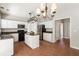 A spacious kitchen featuring white cabinets, black appliances, an island, and tile floors at 144 Nocatee Trl, Woodstock, GA 30188