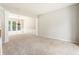 Spacious living room featuring neutral carpeting and large windows, perfect for entertaining at 144 Nocatee Trl, Woodstock, GA 30188