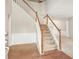 Traditional staircase with wood railings leads to the upper level, showcasing an open foyer at 144 Nocatee Trl, Woodstock, GA 30188