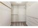 Spacious walk-in closet with multiple shelves for maximum storage and well-organized wardrobe at 144 Nocatee Trl, Woodstock, GA 30188