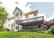 Large backyard features a wooden deck, patio, and lush green grass at 2260 Cobble Creek Ln, Grayson, GA 30017