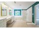 The primary bath features a glass block shower, soaking tub, and vanity with triple sinks at 2260 Cobble Creek Ln, Grayson, GA 30017