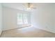 Simple bedroom featuring a ceiling fan and one large window at 2260 Cobble Creek Ln, Grayson, GA 30017