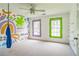 Colorful bedroom featuring painted mural, unique windows, and ceiling fan at 2260 Cobble Creek Ln, Grayson, GA 30017