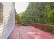 Red stained wooden deck with railings overlooking a lush tree filled yard at 2260 Cobble Creek Ln, Grayson, GA 30017