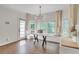Bright dining area featuring hardwood floors, large windows, modern lighting, and a sleek marble table at 2260 Cobble Creek Ln, Grayson, GA 30017