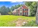 Attractive brick home with well-kept lawn and landscaping, showcasing classic architectural details at 2260 Cobble Creek Ln, Grayson, GA 30017