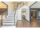 Inviting foyer with hardwood floors, a staircase, and views into the living spaces, with dark trim at 2260 Cobble Creek Ln, Grayson, GA 30017