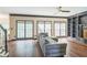 Cozy living room featuring hardwood floors, large windows, built-in shelving, and neutral decor at 2260 Cobble Creek Ln, Grayson, GA 30017