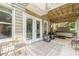 Covered back porch featuring outdoor seating, a jacuzzi, and string lights at 4096 Vinings Mill Se Trl, Smyrna, GA 30080