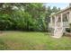 This backyard provides a lush green lawn and a charming porch with stairs at 4096 Vinings Mill Se Trl, Smyrna, GA 30080
