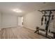 Basement featuring vinyl plank flooring, a fitness machine, and a doorway to another room at 4096 Vinings Mill Se Trl, Smyrna, GA 30080