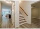 Hall and stairs leading to a finished basement with wood laminate floors at 4096 Vinings Mill Se Trl, Smyrna, GA 30080