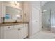 Bathroom with walk-in shower, marble countertops, white cabinets, and large mirror at 4096 Vinings Mill Se Trl, Smyrna, GA 30080