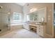 Bright bathroom featuring double vanity, glass shower, soaking tub, and marble countertops at 4096 Vinings Mill Se Trl, Smyrna, GA 30080