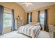 Cozy bedroom with a queen bed, neutral walls, ceiling fan, and three windows at 4096 Vinings Mill Se Trl, Smyrna, GA 30080