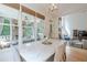 Dining area with a marble table, bright windows, and an open view to the porch and living room at 4096 Vinings Mill Se Trl, Smyrna, GA 30080