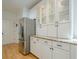 Bright kitchen features granite countertops, stainless steel refrigerator and display cabinets at 4096 Vinings Mill Se Trl, Smyrna, GA 30080