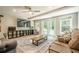 Cozy living room with couches, large windows, a ceiling fan, and doors to a patio at 4096 Vinings Mill Se Trl, Smyrna, GA 30080