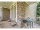 Charming side porch with stone accents and seating area perfect for outdoor relaxation at 4096 Vinings Mill Se Trl, Smyrna, GA 30080