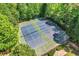 Aerial view of the community tennis courts surrounded by trees, for your active lifestyle at 4096 Vinings Mill Se Trl, Smyrna, GA 30080