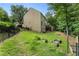 Spacious backyard featuring a black metal fence and mulched garden beds with attractive raised planters at 5828 Paliser Trce, Sugar Hill, GA 30518