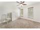 Bright bedroom with two windows, plush carpet, a ceiling fan, and neutral decor at 5828 Paliser Trce, Sugar Hill, GA 30518
