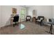Spare bedroom currently purposed as an office space, featuring two windows and neutral carpeting at 5828 Paliser Trce, Sugar Hill, GA 30518