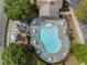 Aerial view of a community pool and playground with ample seating and lounge chairs around the pool deck at 5828 Paliser Trce, Sugar Hill, GA 30518