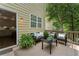 Outdoor deck boasts a cozy seating area with comfortable furniture and views of the surrounding trees and greenery at 5828 Paliser Trce, Sugar Hill, GA 30518