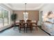 Formal dining room featuring a tray ceiling, hardwood floors, a large window, and elegant furnishings at 5828 Paliser Trce, Sugar Hill, GA 30518