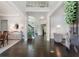 Elegant foyer with high ceilings, hardwood floors, staircase, and views of the dining and living areas at 5828 Paliser Trce, Sugar Hill, GA 30518