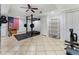 This home gym features a power rack with weights, and exercise machine, and rubber flooring to protect the floor at 5828 Paliser Trce, Sugar Hill, GA 30518