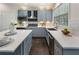 Modern kitchen featuring sleek countertops, stainless steel appliances, stylish backsplash, and gray cabinets at 5828 Paliser Trce, Sugar Hill, GA 30518