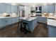 Charming kitchen with stainless steel appliances, gray cabinetry, a central island, and sleek countertops at 5828 Paliser Trce, Sugar Hill, GA 30518