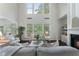 Inviting living room with large windows, neutral furniture, and fireplace creates a comfortable and stylish atmosphere at 5828 Paliser Trce, Sugar Hill, GA 30518