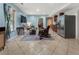 Open living area with large windows, tile floors, recessed lighting, and a view into the kitchen area at 5828 Paliser Trce, Sugar Hill, GA 30518
