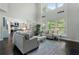 Bright and airy living room with high ceilings, hardwood floors, large windows, and an open-concept layout at 5828 Paliser Trce, Sugar Hill, GA 30518