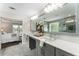 An expansive bathroom features double sinks and an enormous mirror, offering a luxurious and functional space at 5828 Paliser Trce, Sugar Hill, GA 30518