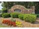 Stone entrance sign to Avonley Creek neighborhood surrounded by colorful landscaping and shrubbery at 5828 Paliser Trce, Sugar Hill, GA 30518