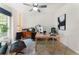 This home office features a ceiling fan, ample natural light, and unique furniture for comfort and function at 5828 Paliser Trce, Sugar Hill, GA 30518
