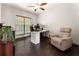A well lit home office featuring a desk, comfortable chair, and a window at 5828 Paliser Trce, Sugar Hill, GA 30518