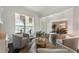 Comfortable sitting room with hardwood floors, neutral decor, and a large window overlooking the front yard at 5828 Paliser Trce, Sugar Hill, GA 30518