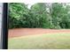 Large backyard with a mulched area and well-maintained lawn, creating a serene and inviting outdoor space at 219 Poplar Nw St, Lilburn, GA 30047