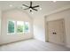 Spacious bedroom with a vaulted ceiling, ceiling fan and large windows offering outdoor views at 219 Poplar Nw St, Lilburn, GA 30047