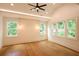 Bedroom with hardwood floors, a vaulted ceiling, and windows providing natural light and outdoor views at 219 Poplar Nw St, Lilburn, GA 30047