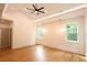 Spacious bedroom with hardwood floors, a vaulted ceiling, and windows providing natural light at 219 Poplar Nw St, Lilburn, GA 30047